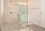 Enjoy a beautiful, and brand new, shower complete with river rock tiling for a modern touch